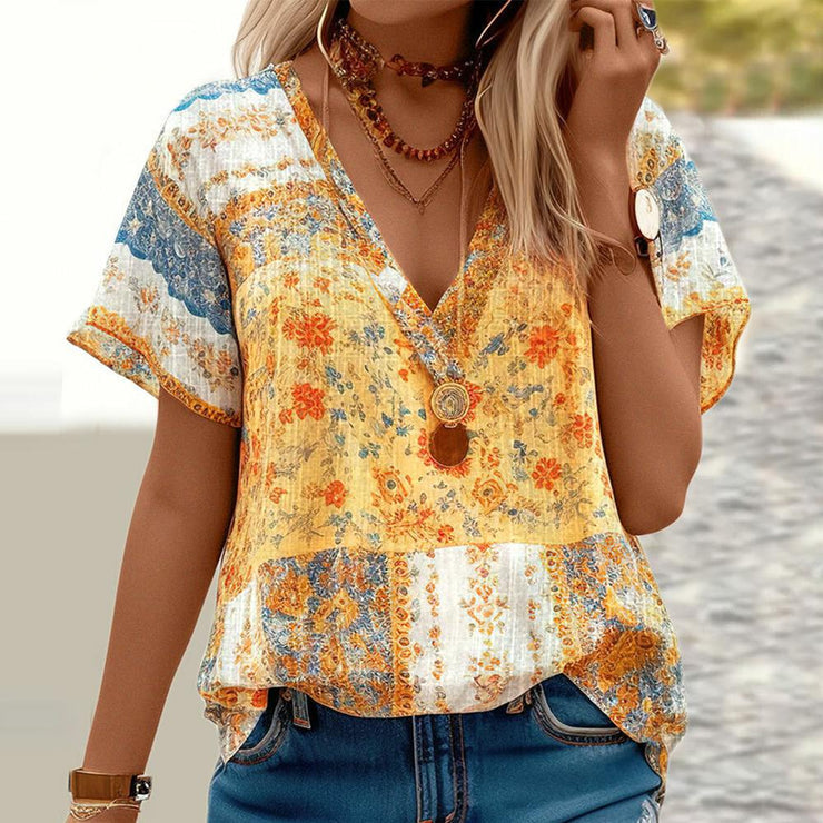 Yellow short sleeve top with V-neck and mixed print