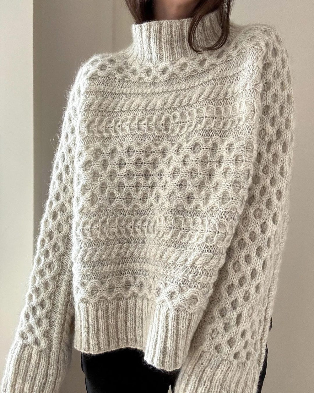 Solid color sweater with high neckline