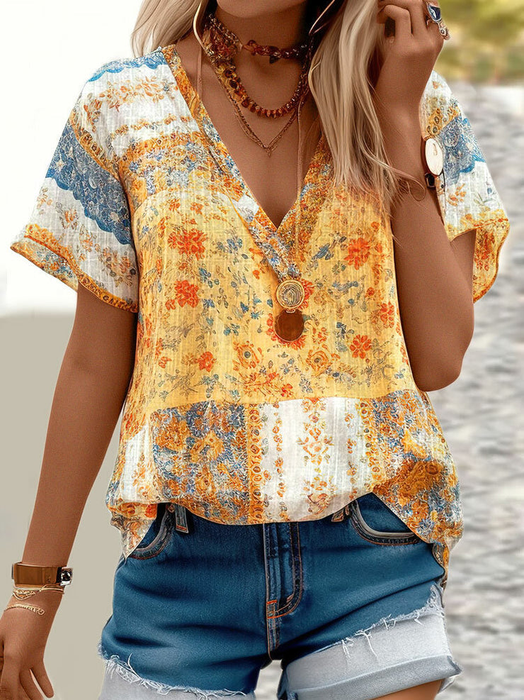 Yellow short sleeve top with V-neck and mixed print