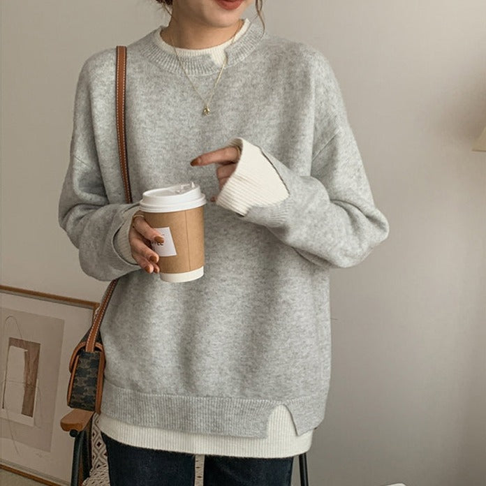 Grey and white oversized sweater with long sleeves and cut-out